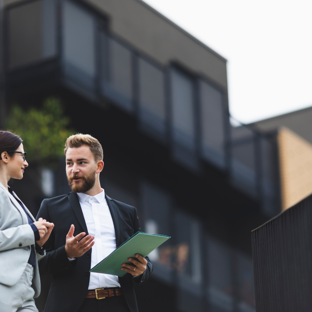 real estate agent in front of black home